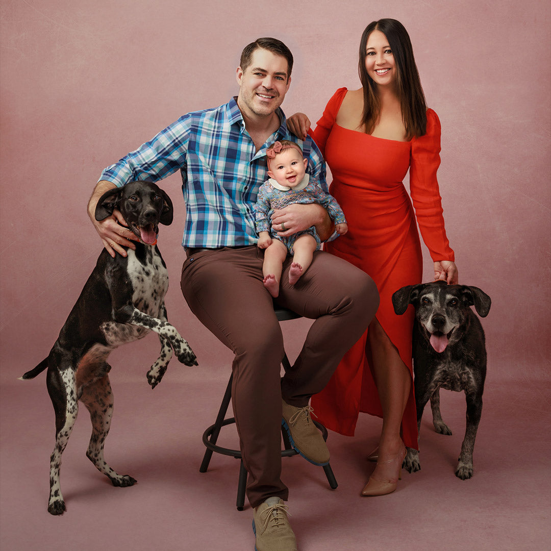 Family photography backdrops - Family of three with two dogs on a pink background